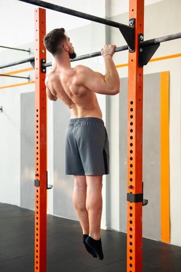 strong-male-athlete-doing-pull-ups-bar-gym_126745-4503